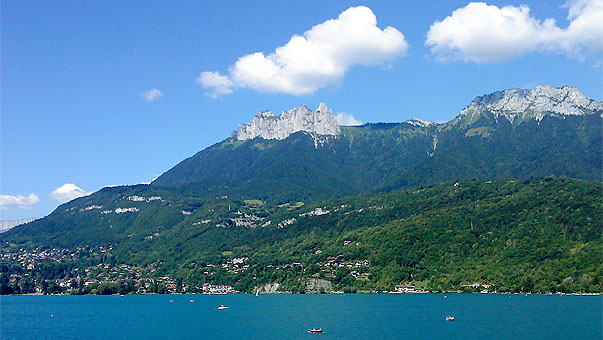 Vue sur le Lac d'Annecy et les montagnes à la sortie du tunnel de la piste cyclable à la hauteur de Duingt